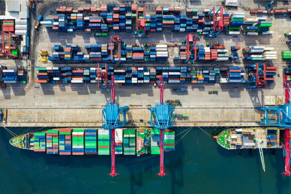 Overhead view of a shipping port with cargo containers and vessels, representing global freight operations and bill of lading processes.